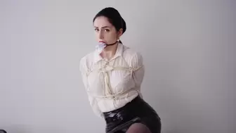 Cute secretary in latex skirt and paper gag