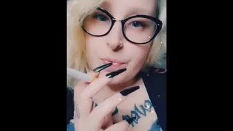 Chick with glasses smokes a cigar