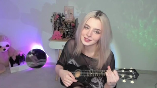Charming blonde slut playing on ukulele and singing in kinky outfit