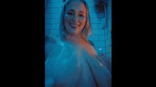 In the bathroom tub playing with bubbles and boobs